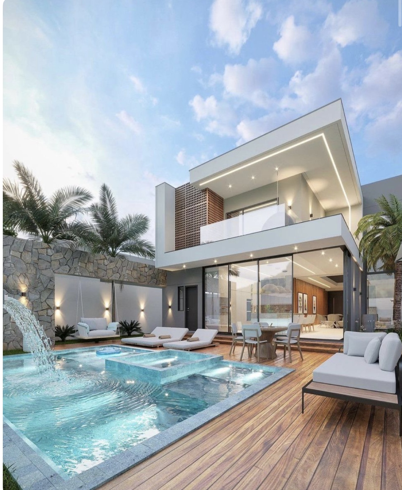 Contemporary courtyard pool with waterfall, sun shelf, submerged seating and feature lighting