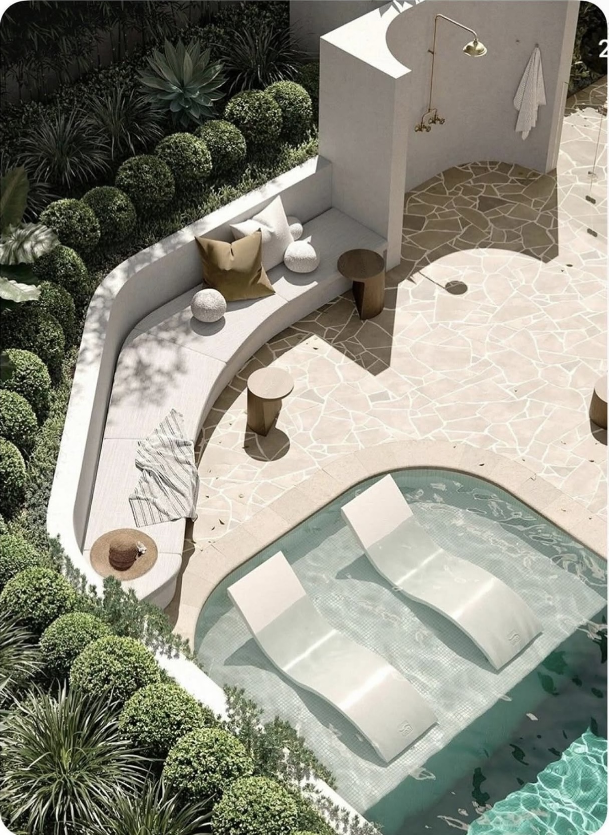 Curved resort-style pool with sun shelf and loungers